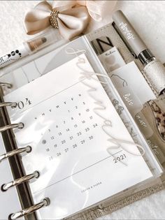 a planner and pen sitting on top of a table