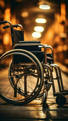 a wheelchair sitting on the ground in front of a building with lights coming from it