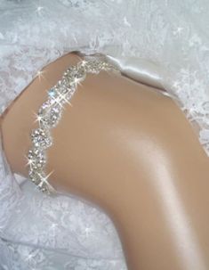 Garter, Weddings, Wedding Garter, Bridal Garter, Bridal, Rhinestone Garter, Crystal Garter, Garder, Wedding Garder,  Bling Garter Rhinestone trim bridal keepsake garter is encrusted with clear Czech crystals. in a unique and regal pattern. Rhinestone crystal and beaded trim is .75" wide and is a unique pattern of rhinestone twists and diamond shape. The crystals are accented with silver beads and the sparkling effect is breathtaking, especially when the light hits it The back is secured with a couple of inches of satin and cotton stretch elastic, so it should fit comfortably while staying in place on your special day. Please send me your thigh size approximately 6 inches above the knee. These are made to order The one pictured fits size 18 to 21 inches. This garter is also available as a s Silver Fitted Bridal Accessories, Elegant Bedazzled Bridal Belt For Wedding, Fitted Rhinestone Bridal Accessories For Party, Fitted Bridal Accessories With Rhinestones For Party, Silver Bedazzled Bridal Belt For Wedding, Fitted Wedding Dress With Rhinestones, Elegant Silver Bedazzled Bridal Accessories, Elegant Bedazzled Silver Bridal Accessories, Adjustable Rhinestone Bridal Accessories