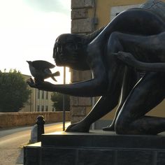 there is a statue that has a cat in it's hand