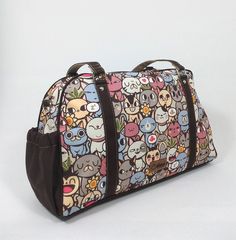 "Ideal for all cat lovers, super cute   fashion traveler shoulder bag with zipper closure, handles, detachable shoulder strap,  two outside pockets (one with zipper closure), and three internal pockets. It is a great handbag for everyday use.   Perfect for all your travel necessities, including makeup, wallet, coins, keys, computer, work items, calculator, and all your extra things.  Waterproof, lightweight, and fashionable.  Size: 5.25\" (length) x 17\" (width) x 11\" (height) Inches. ⭐ Character - All Cats 🐱: All cats is a design that shows 30 different cats. In this catopia you can find all types of cats, from fluffy grumpy grandpa to playful kittens. The cat ambassador of All Cats is Samuel, our troublemaker. He loves games, music, movies and food - He definitely loves food-, but more Cute Travel Tote Satchel, Cat Design Shoulder Satchel, Travel Shoulder Bag With Cat Print, Cat Design Satchel Shoulder Bag, Cute Travel Shoulder Bag With Zipper Closure, Cat Print Shoulder Travel Bag, Cute Shoulder Bag With Zipper Closure For Travel, Rectangular Travel Bag With Cat Print, Cute Shoulder Bag With Zipper For Everyday Use