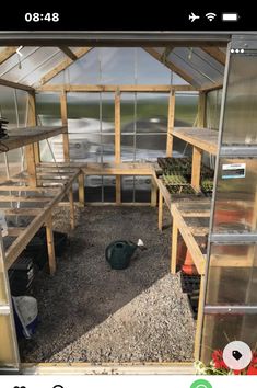 the inside of a greenhouse with lots of plants in it