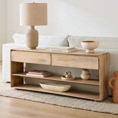 a living room scene with focus on the coffee table and vases in front of the couch