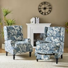 a living room with two blue chairs and a clock on the wall above it,