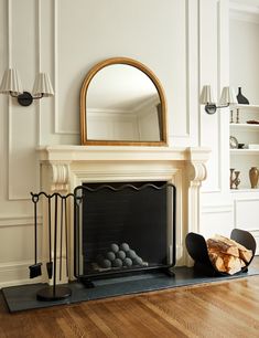 a living room with a fire place and mirror