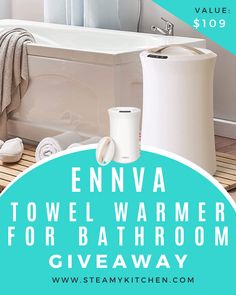 a bathtub with towels on the floor and a water heater next to it