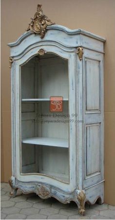 an old white china cabinet with glass doors