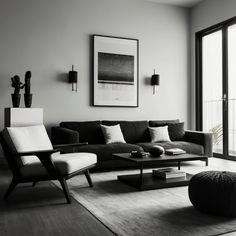 a black and white photo of a living room with couches, chairs, coffee table and artwork on the wall