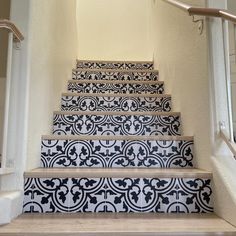 the stairs are decorated with black and white tiles