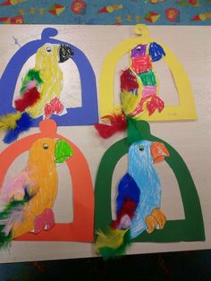 three colorful parrots are sitting on top of each other in the shape of letters