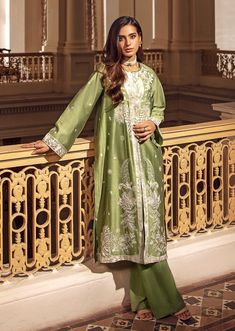 2 Piece - Embroidered Suit Make a bold statement with this 2-piece green dress, crafted from a combination of silk cotton net and viscose raw silk, with intricate embroidery for added texture and style. The full-sleeved jacket features a crew neckline, plain back, and embroidered border, while the trousers feature a boot cut design. Perfect for any occasion, this dress will be sure to turn heads. 2-Piece Front Open Jacket with TrousersMake a fashionable statement in green front open jacket featu Green Designer Dupatta For Spring, Designer Green Kurta For Spring, Pista Green Silk Kurta For Spring, Pista Green Long Sleeve Silk Kurta, Spring Cotton Silk Sets With Zari Work, Formal Green Kurta With Chikankari Embroidery, Green Cotton Silk Dress With Resham Embroidery, Green Cotton Silk Dresses With Zari Work, Spring Designer Wear Cotton Silk Dress