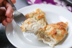 a white plate with some food on it and a fork in the middle of it