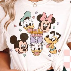 a woman wearing a mickey mouse graphic shirt