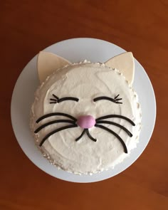 a white cake with a cat face on it