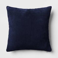 a dark blue pillow on a white wall