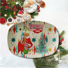 an oval platter decorated with christmas decorations