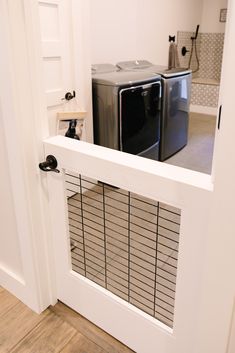 an open door leading to a washer and dryer