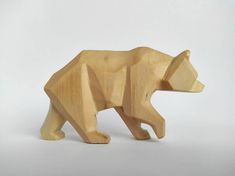 a wooden toy bear on a white background