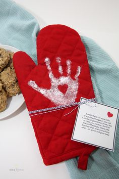 a red oven mitt sitting on top of a white plate filled with cookies next to a bowl of oatmeal