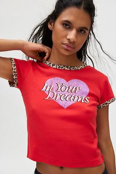 Cheeky graphic tee in a slim & cropped fit. Designed with a crew neckline & short sleeve with leopard print ringer detailing. Topped with a ‘In Your Dreams’ heart graphic across the front. Only at Urban Outfitters. Features In Your Dreams leopard graphic ringer tee Graphic baby tee -Soft & stretchy knit Crew neckline and short sleeves with leopard ringer trim ‘In your dreams’ heart graphic at the chest Slim fit Cropped length Easy pull-over style UO exclusive Content + Care 100% Cotton Machine w Leopard Graphic, Applique Tee, Graphic Baby Tee, Vintage Graphic Tees, Women's Graphic Tees, Baby Graphic Tees, Heart Graphic, Red Fits, Graphic Tees Vintage