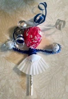 an ornament made out of paper and ribbon