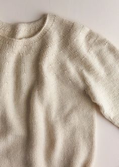 a white sweater laying on top of a table