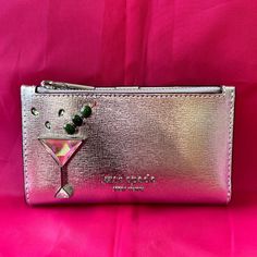 Elevate Your Style With This Chic And Sophisticated Kate Spade New York Wallet. This Slim Bifold Wallet Features An Embellished Martini Glass Design, Perfect For Those Who Love A Little Bit Of Sparkle And Shine. Made Of High-Quality Leather, This Wallet Is Durable And Stylish. With Credit Card And Folding Features, This Wallet Is Both Practical And Fashionable. The Metallic Silver Color And Metal Theme Add A Touch Of Elegance To Any Outfit. The Size Is Perfect For On-The-Go Use, And The Unisex D Designer Clutch For Cocktail Events, Chic Embellished Clutch For Cocktail, Kate Spade Designer Party Bags, Designer Kate Spade Party Bags, Designer Party Bags By Kate Spade, Elegant Party Wallets With Card Slots, Evening Clutch With Card Slots And Bifold Design, Gold Clutch With Card Slots For Evening, Kate Spade Elegant Formal Clutch