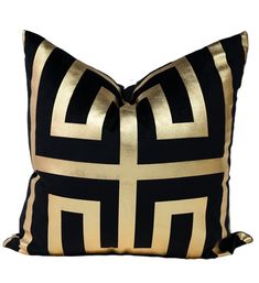 a black and gold pillow on a white background