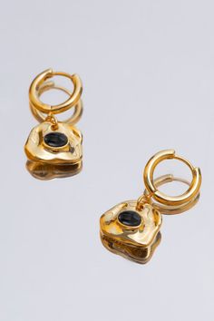 these stunning earrings feature a unique lock-shaped design in radiant gold, symbolizing the idea of securely locking in cherished memories and emotions. Each earring is adorned with sublet obsidian, carefully selected to add a touch of color and brilliance to every movement. The hoop drop style creates a sense of movement and grace, making them perfect for both formal occasions and everyday wear. 18k gold plated brass Obsidian Earring size: 3.2 cm x 1.6 cm / 1.26 inch x 0.6 inch Hoop diameter: Wedding Dress Jewelry, Hoop Drop Earrings, Custom Made Clothing, Dress Jewelry, Stunning Earrings, Eyewear Design, Accessories Jewelry Earrings, Gold Drop Earrings, Cherished Memories