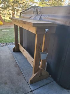 an outdoor bbq grill built into the side of a house with a cover over it