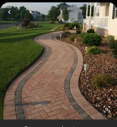 a brick walkway in front of a house