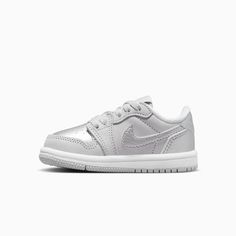 Jordan 1 Retro Low "Silver"Baby/Toddler ShoesEvery Jordan Retro is a classic sneaker done up in new colors and textures for a fresh look. With metallic silver leather, this iteration gives little feet stand-out style. Plus, premium materials and accents keep the look modern and on point. Real and synthetic leather in the upper helps add durability and structure.Foam sockliner helps cushion little feet.Rubber in the outsole helps give kiddos the traction they need. More Details Classic laces The Tops And Bottoms, Shoes Grey, Wings Logo, Kids Jordans, Air Jordan 1 Retro, Jordan 1 Retro, Classic Sneakers, Jordan Retro, Toddler Shoes