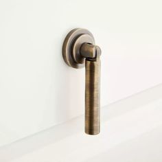 a close up of a door handle on a white wall