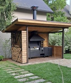 an outdoor kitchen is built into the side of a house