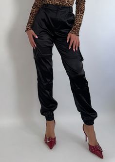 Elevate your wardrobe with our Luxe Satin Cargo Joggers. Featuring functional cargo pockets, a high waist with button closure, and an elastic cinch bottom. Look chic without sacrificing comfort. Style them down with your favorite sneaker or up with a heel. Jill is 5'3" and wearing size Small. 86% POLYESTER 14% SPANDEX HAND WASH COLD, DO NOT BLEACH, LINE DRY, DO NOT IRON, DO NOT DRY CLEAN. Sweater Blazer, Cargo Joggers, Look Chic, Sweater Dress, Topshop, High Waisted, Wardrobe, How To Wear, Black