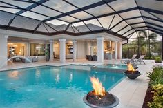 an indoor swimming pool with fire in the middle