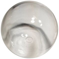 a round metal object with holes in the center and an oval hole at the bottom