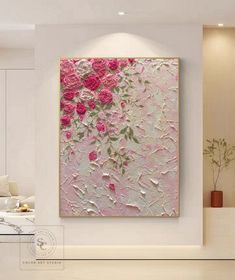 a painting with pink flowers on it in a living room