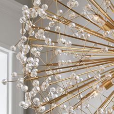 a gold chandelier with crystal balls hanging from it's centerpieces