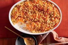 a casserole dish filled with carrots and nuts