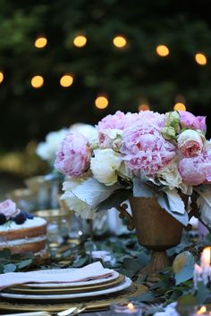 a table topped with lots of flowers and plates