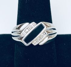 "This circa 1980s classic Post-Modernist sterling silver men's ring is set with single cut ( 16 facets) round diamonds, and onyx. It features a masculine, edgy geometric design, which captures the classy, timeless feel of its era of origin. It is a size 10.5 US. I don't recommend sizing this ring due to the setting of the onyx. This is the perfect ring for everyday wear, and is in fantastic vintage condition! SPECIFICS: * SIZE: 10.5 * WEIGHT: 8.60gr * DIAMOND WIEGHT: 4 Single cut (16 facets) rou Formal Sterling Silver Signet Ring With Diamond Accents, Classic Formal Signet Ring Channel Set, Classic Formal Signet Ring With Channel Set, Art Deco Silver Signet Ring With Polished Finish, Silver Art Deco Signet Ring With Polished Finish, Modernist Diamond Ring For Formal Occasions, Formal Silver Signet Ring With Single Cut Diamonds, Modernist Signet Ring For Formal Occasions, Modernist Formal Signet Ring