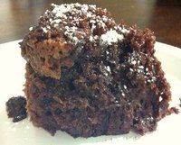 a close up of a piece of cake on a plate with the words crock pot chocolate cake