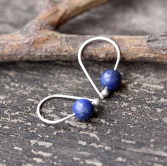 "Lapis lazuli sterling silver earrings Dainty 3/4\" sterling silver budded open hoops with 6mm dark blue pyrite flecked lapis lazuli stones. Made to order ~ minor variations in stone character ♥ Open hoops are applied to your ears by grasping the open ends in each hand and gently pulling one end up and one end down, then simply slide them in your ear. DO NOT pry them open then pinch them closed, they will lose shape and not close properly. HOW TO properly put on any kind of hoop earring. Copy an Unique Handmade Sterling Silver Cartilage Earrings, Minimalist Blue Wire Wrapped Earrings, Dainty Handmade Drop Cartilage Earrings, Handmade Dainty Drop Cartilage Earrings, Nickel-free Blue Cartilage Earrings As Gift, Handmade Lapis Lazuli Jewelry For Everyday, Minimalist Handmade Dangle Cartilage Earrings, Handmade Minimalist Lapis Lazuli Jewelry, Handmade Minimalist Drop Cartilage Earrings