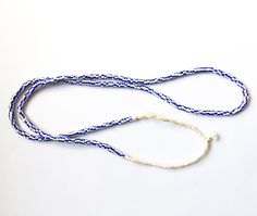 A strand necklace comprised of 3.5mm wide Venetian glass beads plus 5 inches of cotton tie, so 26 inch length in total, so like a choker. These are authentic antique blue and white-heart beads (blue and white stripes on the outside and white on the inside). The beads are handmade and vary in length a bit from 1.7mm to 2.8mm. These blue and white beads were made in Venice, Italy in the 1900's. Venetian glass beads were traded around the world as part of the fascinating world of antique trade bead Traditional Adjustable Single Strand Beaded Necklace, Traditional Adjustable Single Strand Beaded Necklaces, Blue Lariat Beaded Necklace For Beach, Blue Lariat Beaded Necklaces For Beach, Blue Single Strand Beaded Necklace For Festival, Frog Necklace, Antique Blue, Venetian Glass, Trade Beads