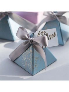 two small blue boxes with silver ribbons and bows on them, one is for you