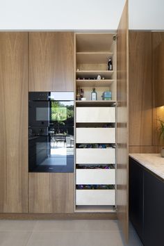 a kitchen with wooden cabinets and white drawers