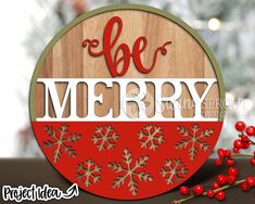 a wooden sign that says be merry with snowflakes and berries on the table