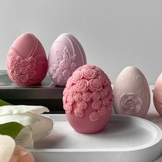 some pink and white decorated eggs on a table