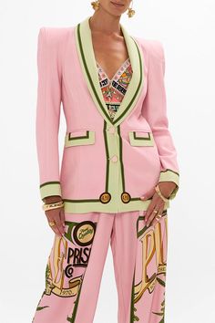 a woman in a pink suit and matching pants